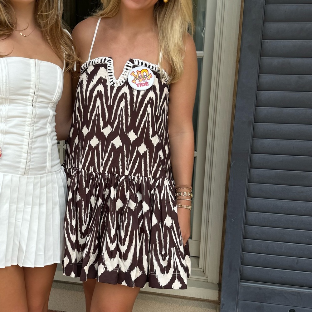 White Pleated Dress and Brown Patterned Dress